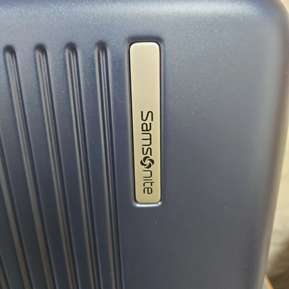 SAMSONITE NAVY BLUE HARD-SHELL SUITCASE WITH FOUR SPINNER WHEELS
