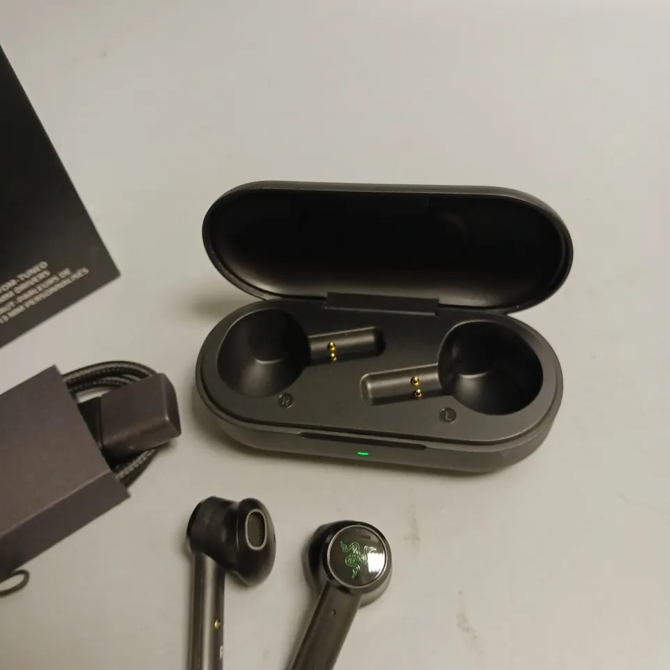 LOT OF 5 BOXED RAZER WIRELESS HEADPHONES IN BLACK AND GREEN INCLUDES CHARGING CASE, CABLE, WRIST STRAP AND SPARE BUDS