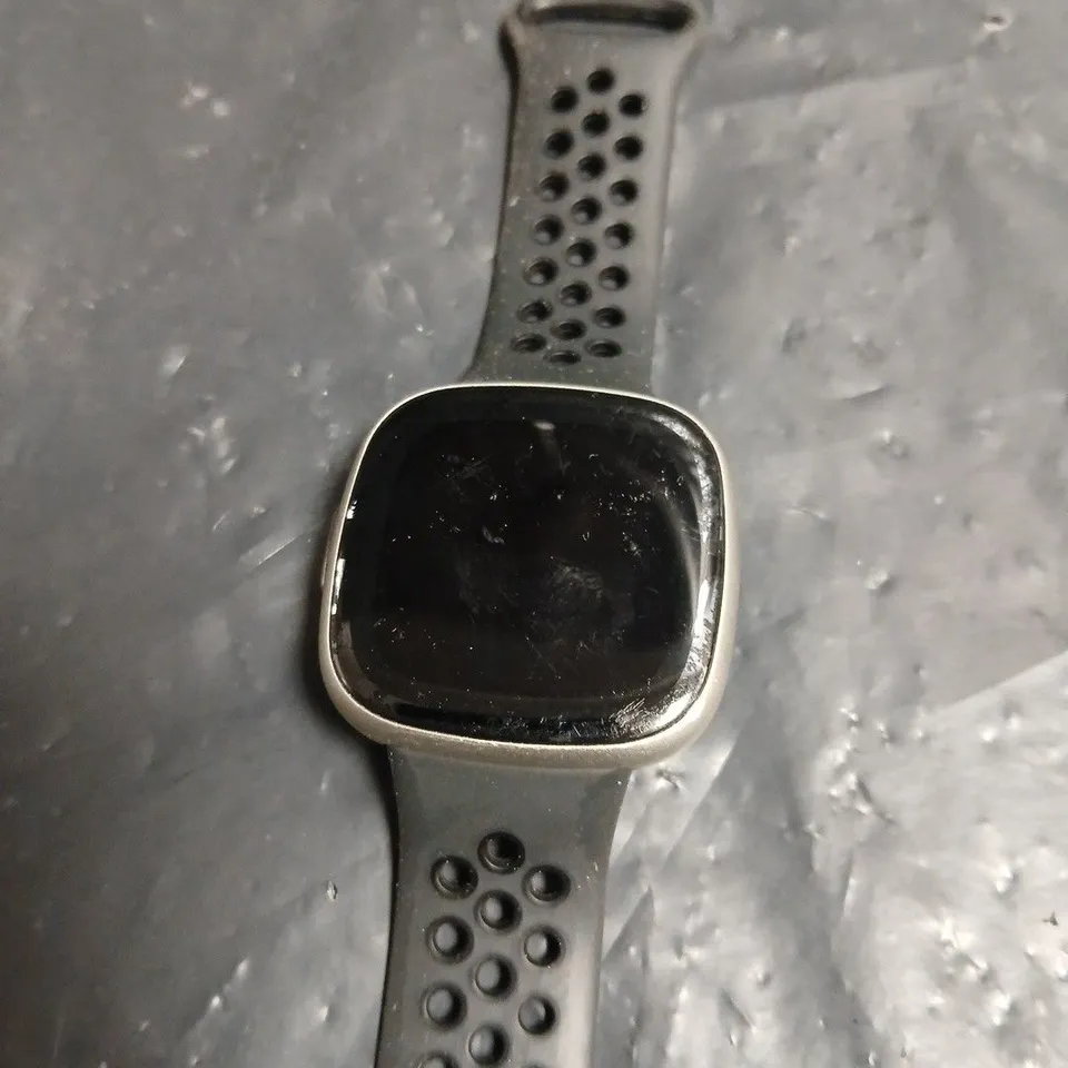 FITBIT SMARTWATCH WITH BLACK PERFORATED STRAP – SQUARE-FACE