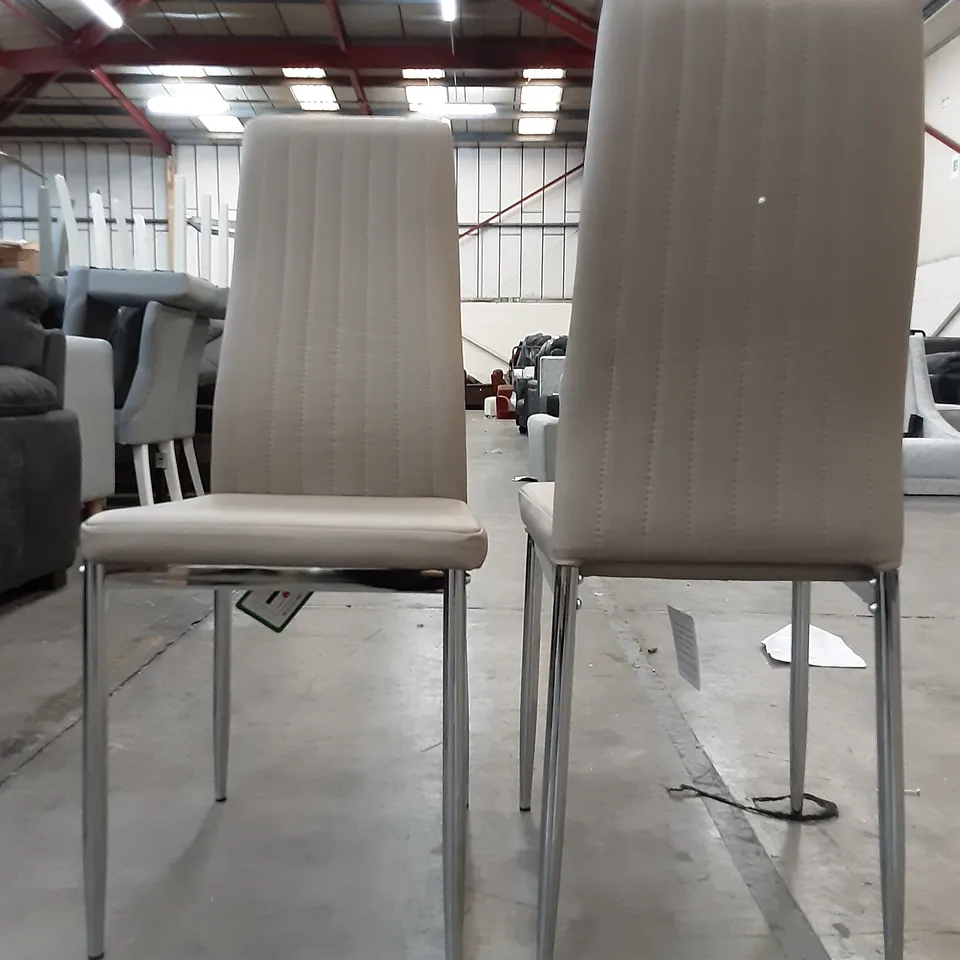 SET OF 2 PU LEATHER DINING CHAIRS IN NUDE BEIGE , ONE CHAIR HAS A SMALL TEAR
