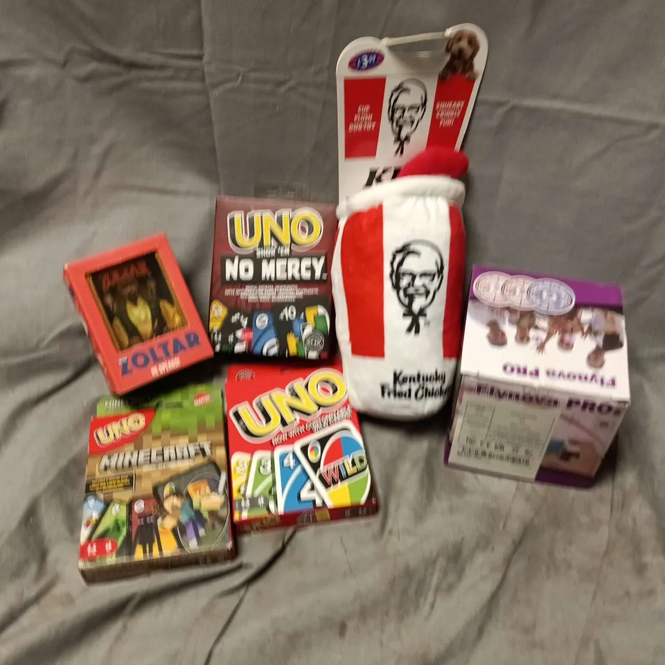 APPROXIMATELY 10 ASSORTED TOYS & GAMES PRODUCTS TO INCLUDE UNO NO MERCY GAME, MINI ZOLTAR, KFC DOG TOY, ETC