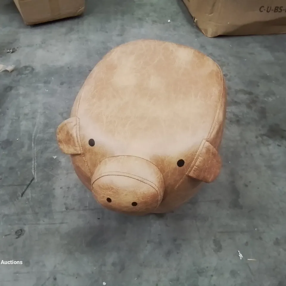A FAUX LEATHER UPHOLSTERED PIGGY POUFFE 