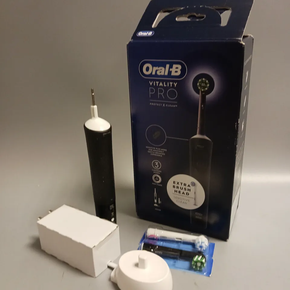 BOXED ORAL B VITALITY PRO ELECTRIC TOOTHBRUSH IN BLACK AND WHITE INCLUDES CHARGING STAND AND 2 BRUSH HEADS
