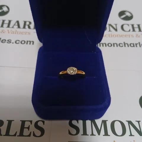 18CT GOLD SOLITAIRE RING WITH A SEMI-RUBOVER SET NATURAL DIAMOND