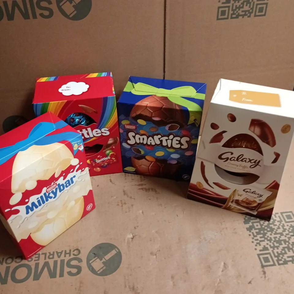 4 ASSORTED EASTER EGGS TO INCLUDE SKITTLES, SMARTIES, MILKYBAR, ETC