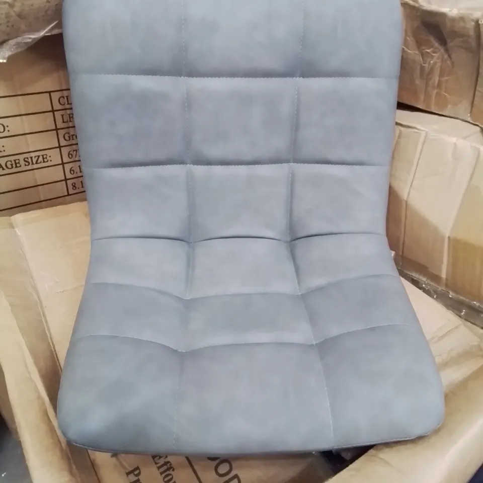 A BOXED PAIR OF GREY FAUX LEATHER UPHOLSTERED DINING CHAIRS