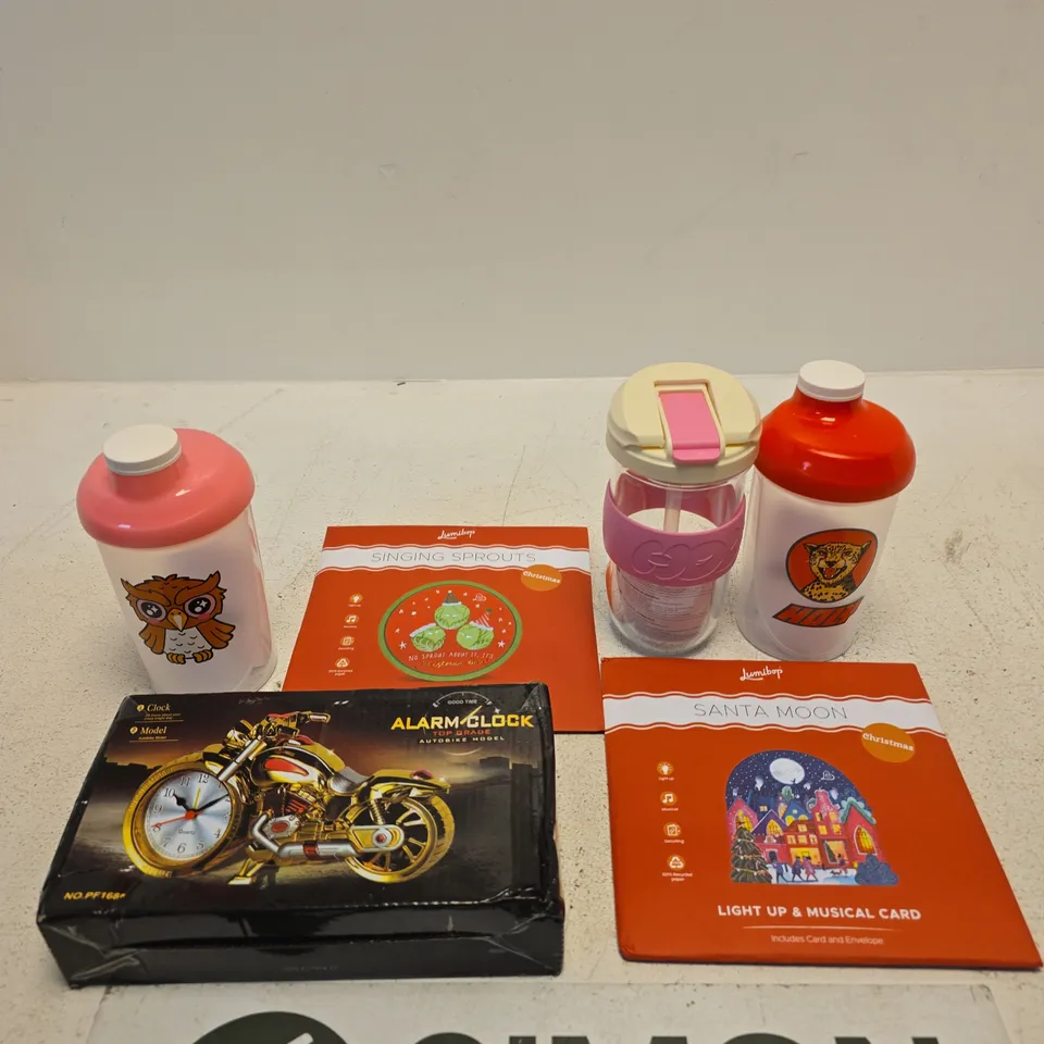 APPROXIMATELY 10 ASSORTED ITEMS INCLUDING LUMIBOP SANTA MOON LIGHT UP & MUSICAL CARD, HOLY SHAKER BOTTLE AND AN AUTOBIKE MODEL ALARM CLOCK