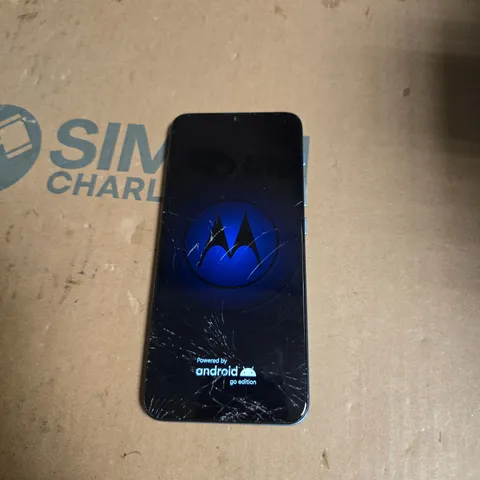 Motorola Smartphone – Blue hex-pattern back, cracked front screen