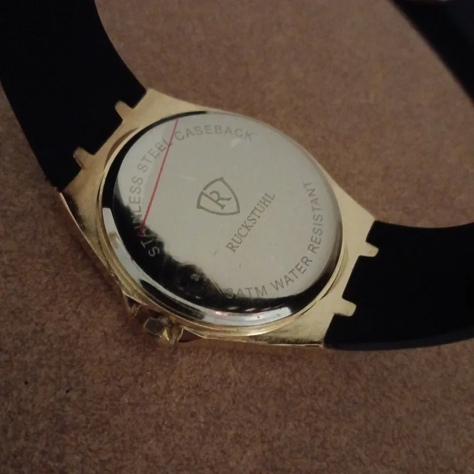 RUCKSTUHL GOLD COLOUR WRISTWATCH WITH BLACK RUBBER STRAP