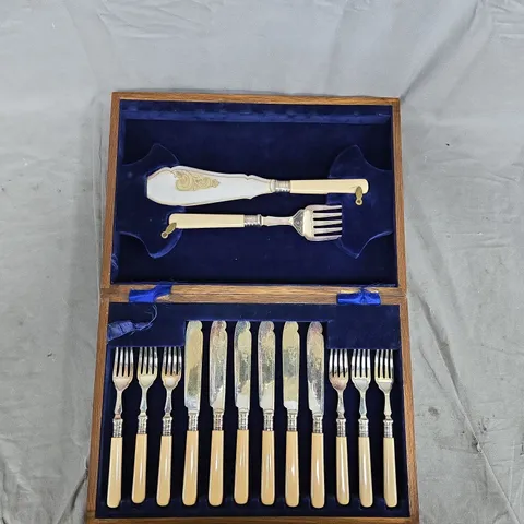 VINTAGE CUTLERY SET IN WOODEN BOX WITH CREAM HANDLES AND BLUE VELVET INTERIOR 