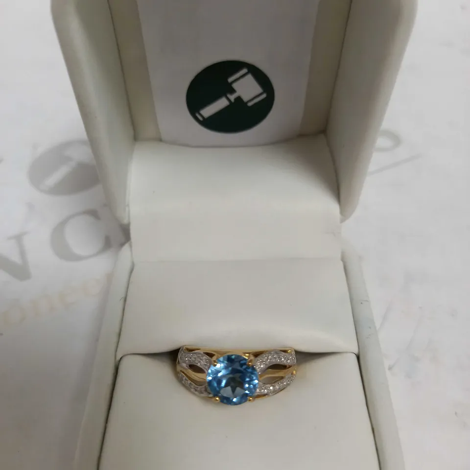 DESIGNER 9CT YELLOW GOLD RING SET WITH A BLUE TOPAZ AND DIAMONDS WEIGHING +-2.10CT