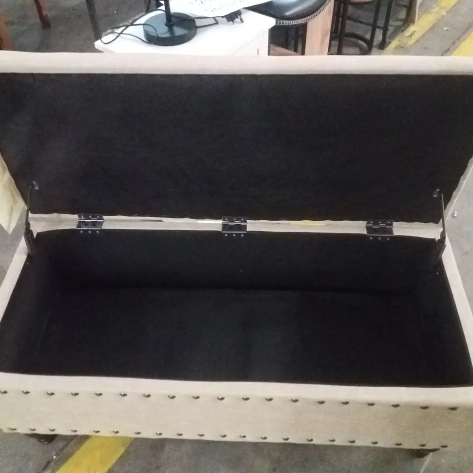 ANIELLE UPHOLSTERED OTTOMAN STORAGE BENCH - TAN/BRUSHED BRASS NAILHEAD