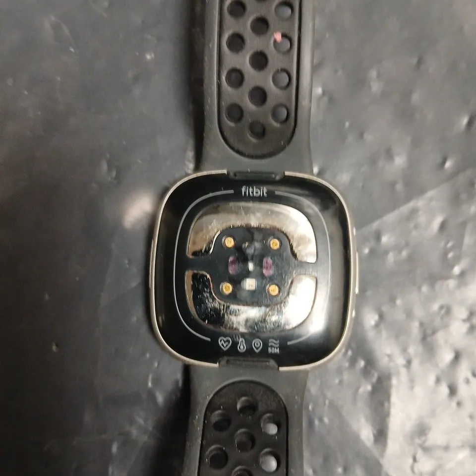 FITBIT SMARTWATCH WITH BLACK PERFORATED STRAP – SQUARE-FACE