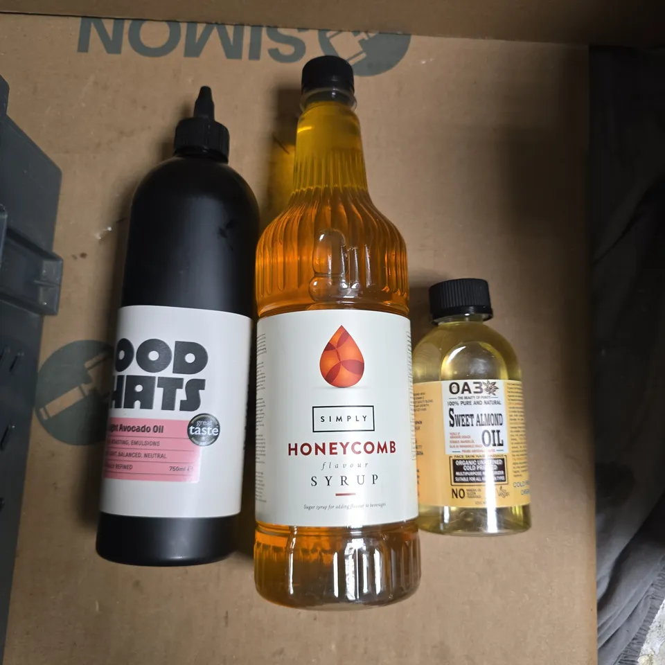 A TOTE OF MIX ITEMS TO INCLUDE HONEY COMB SYRUP, SWEET ALMOND OIL AND CHOCOLATES