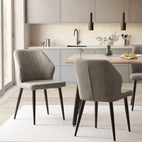 A BOXED PAIR OF GREY FAUX LEATHER UPHOLSTERED SIDE CHAIRS