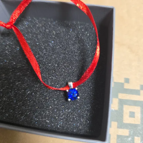 ANGARA BLUE GEMSTONE PENDANT ON RED CORD – BOXED