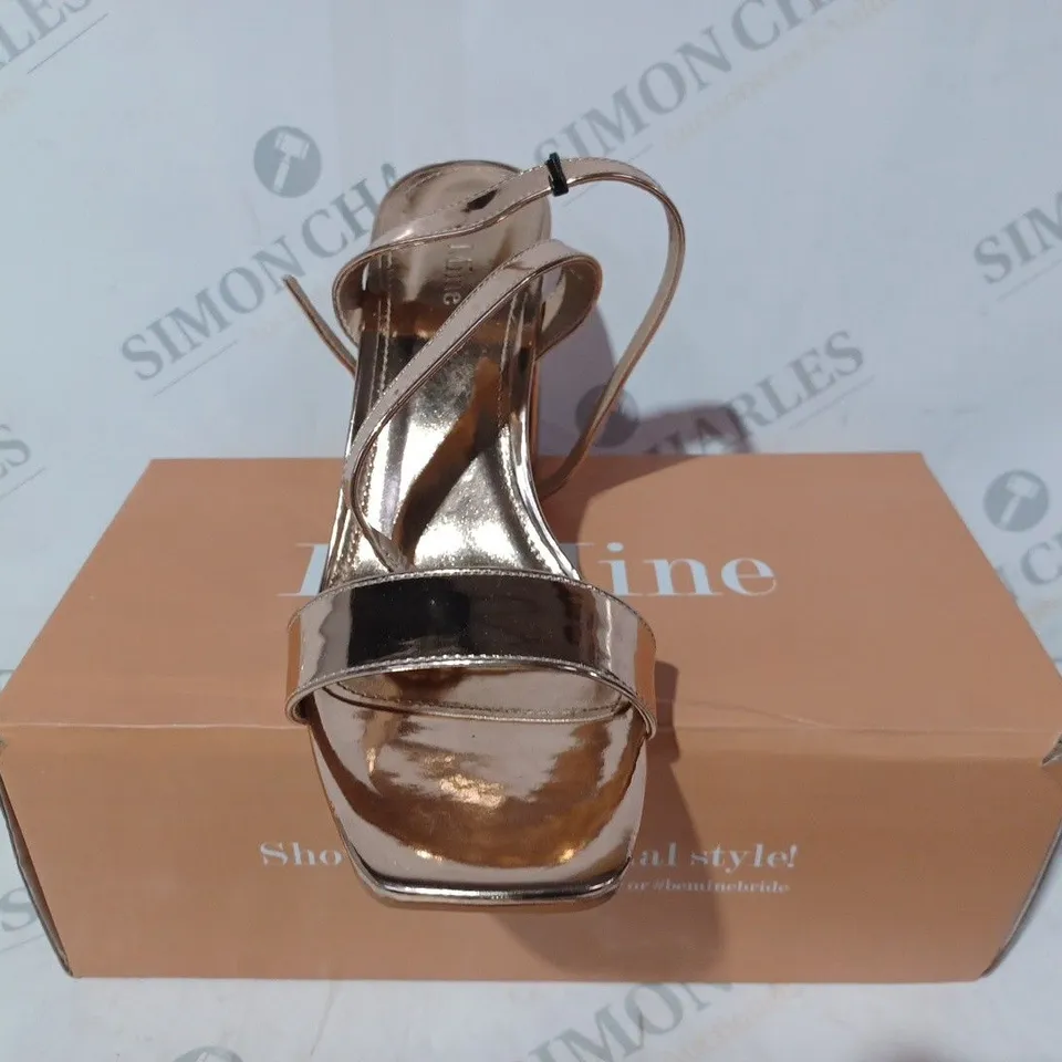 BOXED PAIR OF BE MINE BRIDAL WINK HEELED SANDALS IN METALLIC ROSE GOLD COLOUR SIZE 7