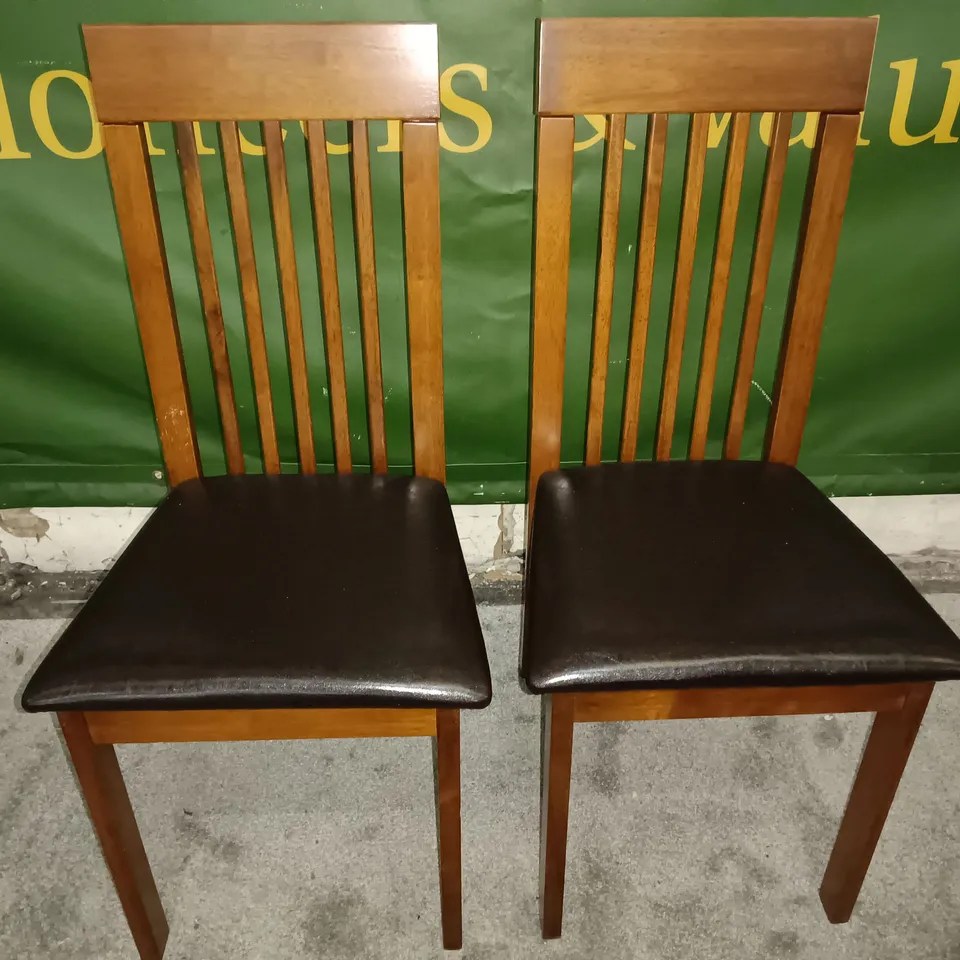 PAIR OF WOODEN SLAT BACK DINING CHAIRS WITH BLACK FAUX LEATHER SEAT PADS 