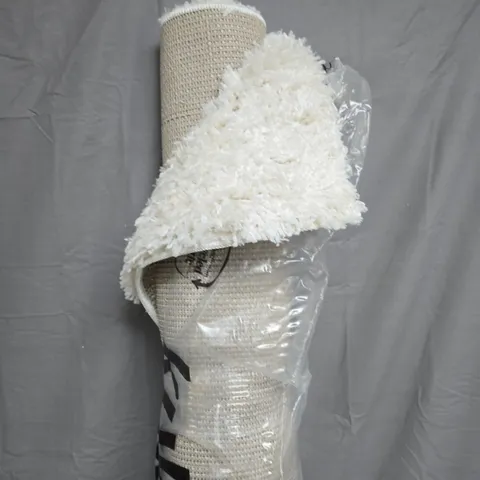 CREAM SHAG RUG, ROLLED IN PLASTIC WRAP