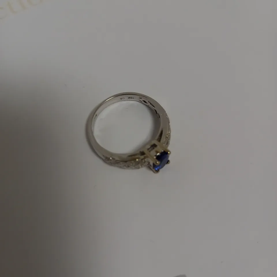 DESIGNER 18CT WHITE GOLD RING SET WITH AN OVAL CUT TANZANITE AND DIAMOND SHOULDERS, WEIGHING +-0.91CT