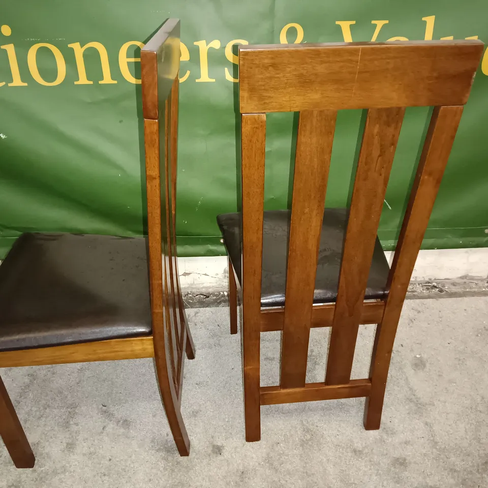 PAIR OF WOODEN DINING CHAIRS WITH BLACK FAUX LEATHER SEAT PADS 