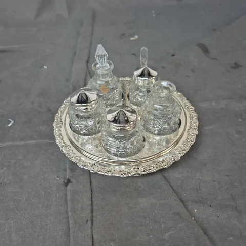 SILVER-PLATED CRUET SET ON ORNATE TRAY WITH GLASS BOTTLES