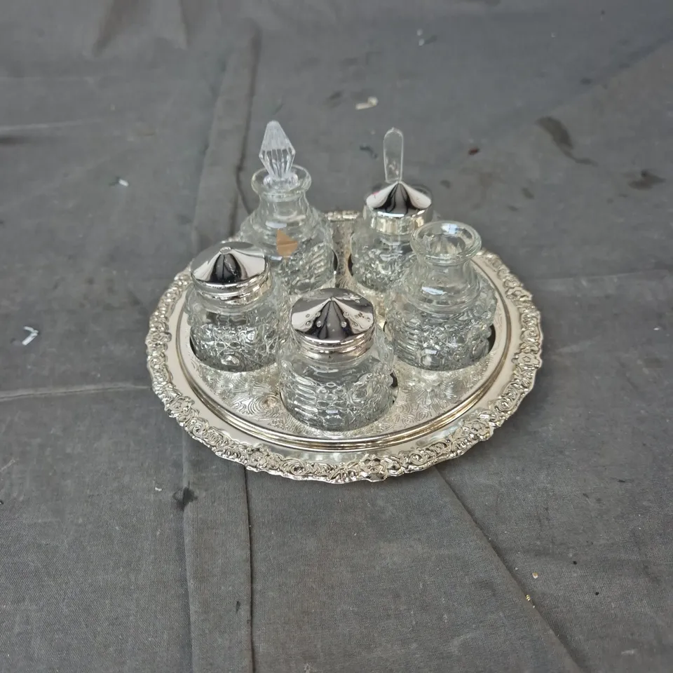 SILVER-PLATED CRUET SET ON ORNATE TRAY WITH GLASS BOTTLES