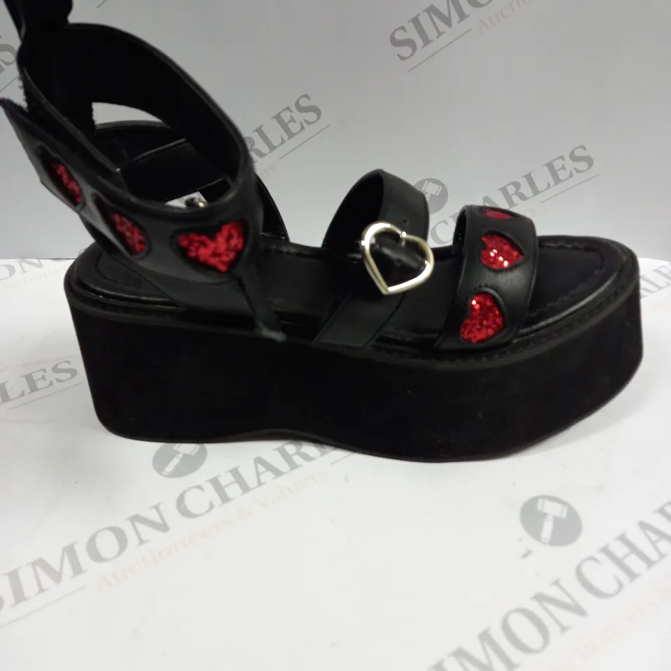 PAIR OF KOI FOOTWEAR ROGUE LOVERGIRL FLATFORM HEART BLACK SANDALS - SIZE UNSPECIFIED 