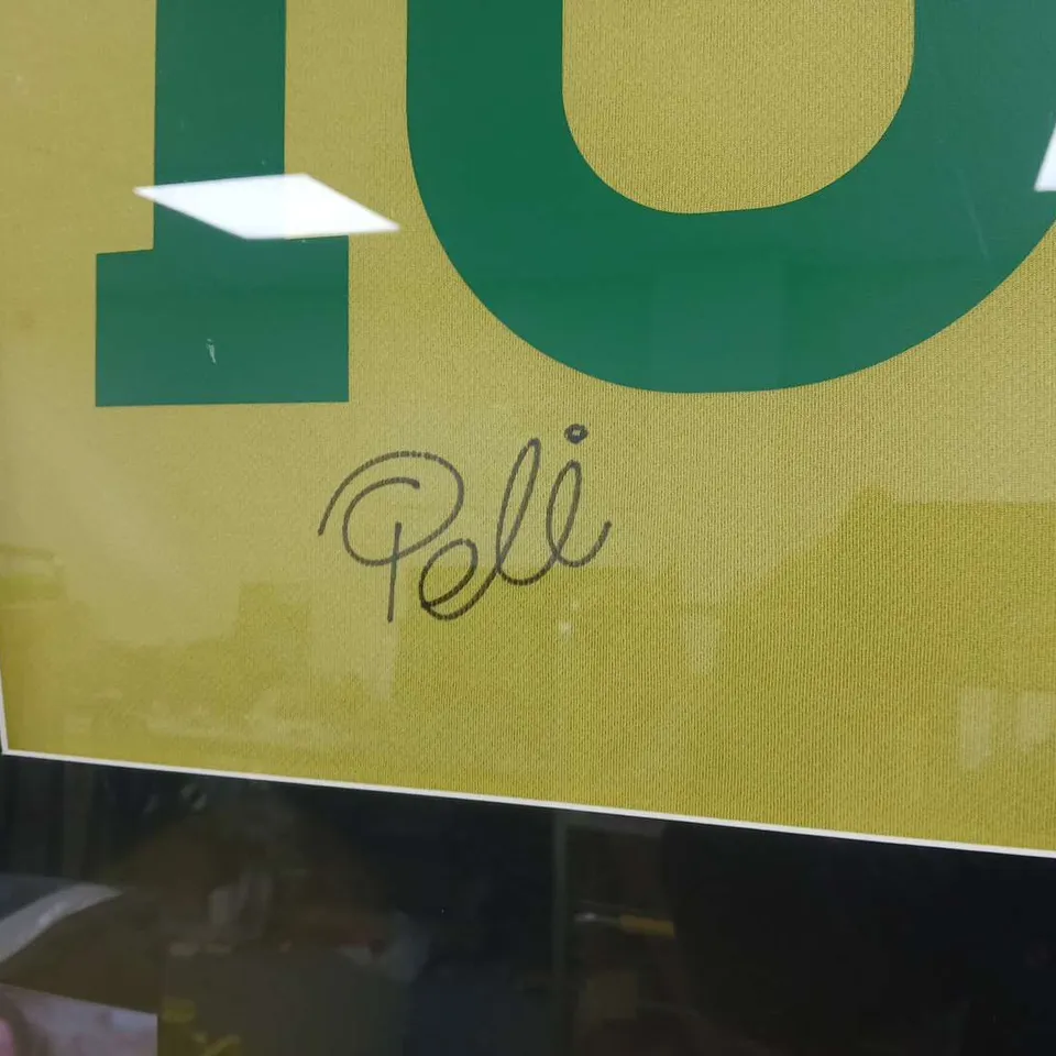 FRAMED PELE PRESENTATION WITH THE ICONIC #10 BRAZIL SHIRT SIGNED 