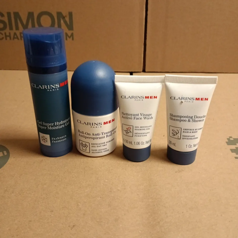 LOT OF 4 CLARINS PARIS MEN BATH AND BODY PRODUCTS TO INCLUDE ROLL ON DEODORANT, SUPER MOISTURE GEL AND FACE WASH - TRIAL SIZES