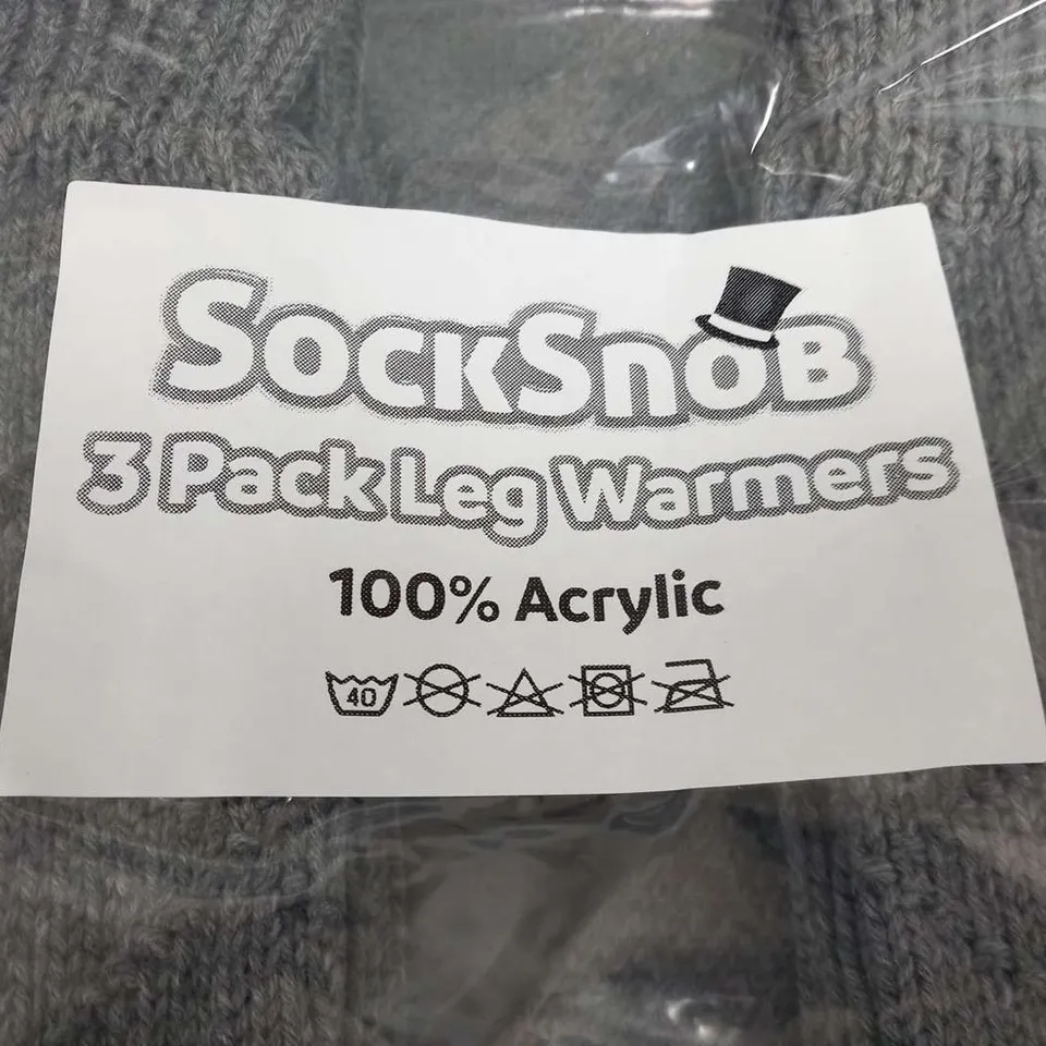 APPROXIMATELY 34 PACKS OF THREE PAIRS OF SOCK SNOB LEG WARMERS 100% ACRYLIC GREY