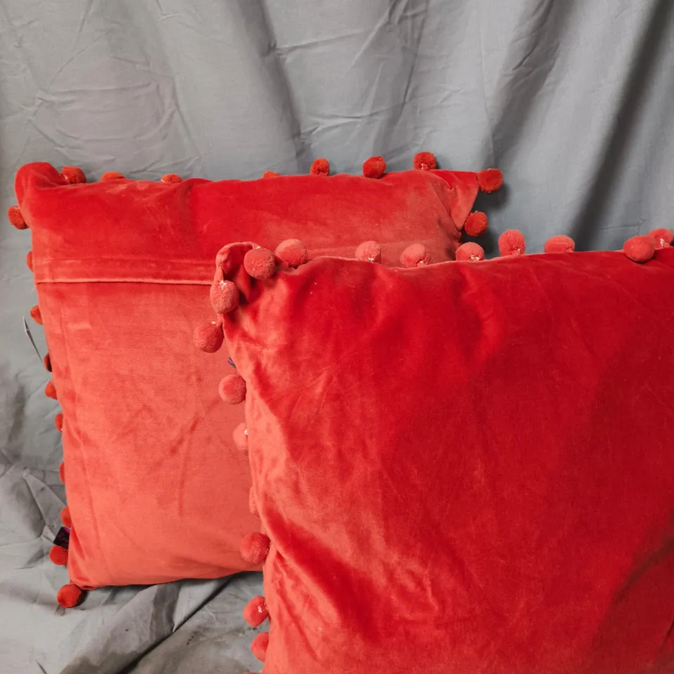 PAIR OF ORANGE VELVET FEEL CUSHIONS WITH POM-POM TRIM