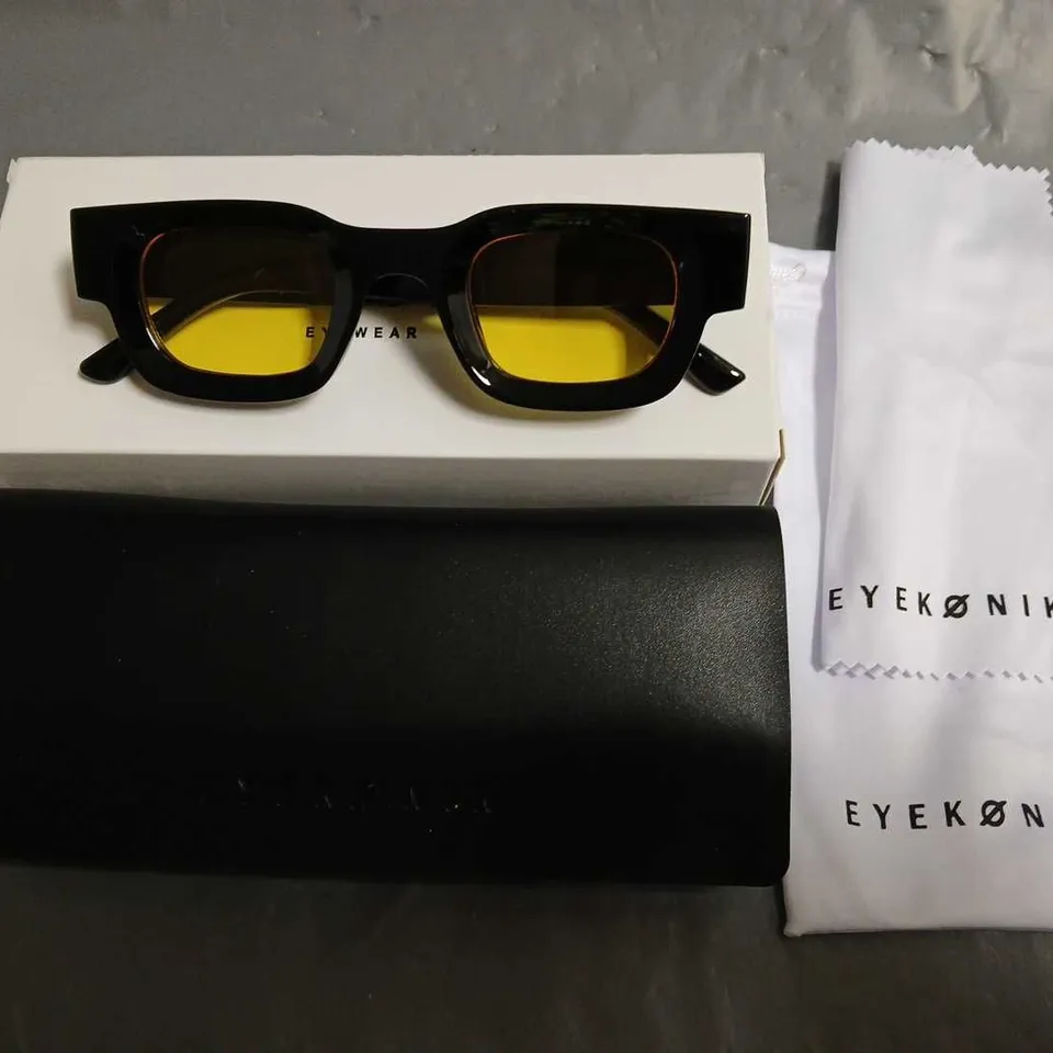 BOXED PAIR OF EYEKONIK BLACK FRAMED GLASSES WITH YELLOW TINT LENS