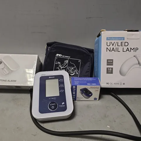 TOTE OF APPROXIMATELY 8 ASSORTED ITEMS TO INCLUDE - UV/LED NAIL LAMP , BEDWETTING ALARM , PREMIUM BLOOD GLUCOSE MONITOR ETC