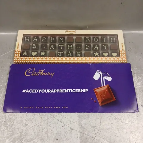 LOT OF 2 ASSORTED FOOD ITEMS TO INCLUDE - THORTONS HAPPY BIRTHDAY CHOCOLATE - CADBURY DAIRY MILK CHOCOLATE GIFT
