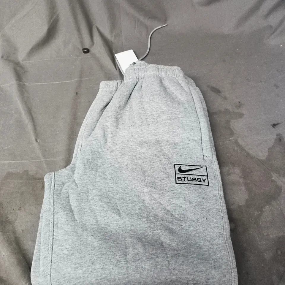 NIKE STUSSY FLEECED TRACKSUIT BOTTOMS -  SIZE XS