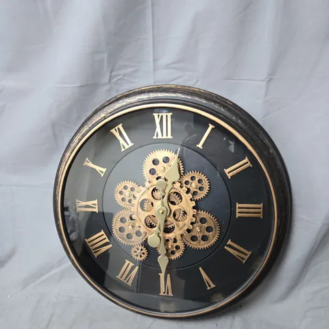 BRASS AND BLACK SKELETON WALL CLOCK WITH EXPOSED GEARS AND ROMAN NUMERALS