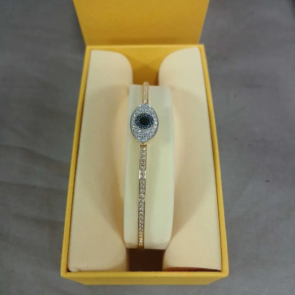 SWAROVSKI GOLD-TONE BRACELET WITH BLUE CENTRE GEMSTONE