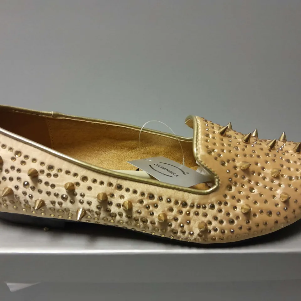 APPROXIMATELY 13 CASANDRA SPIKED SLIPONS IN CHAMPAGNE SATIN IN VARIOUS SIZES
