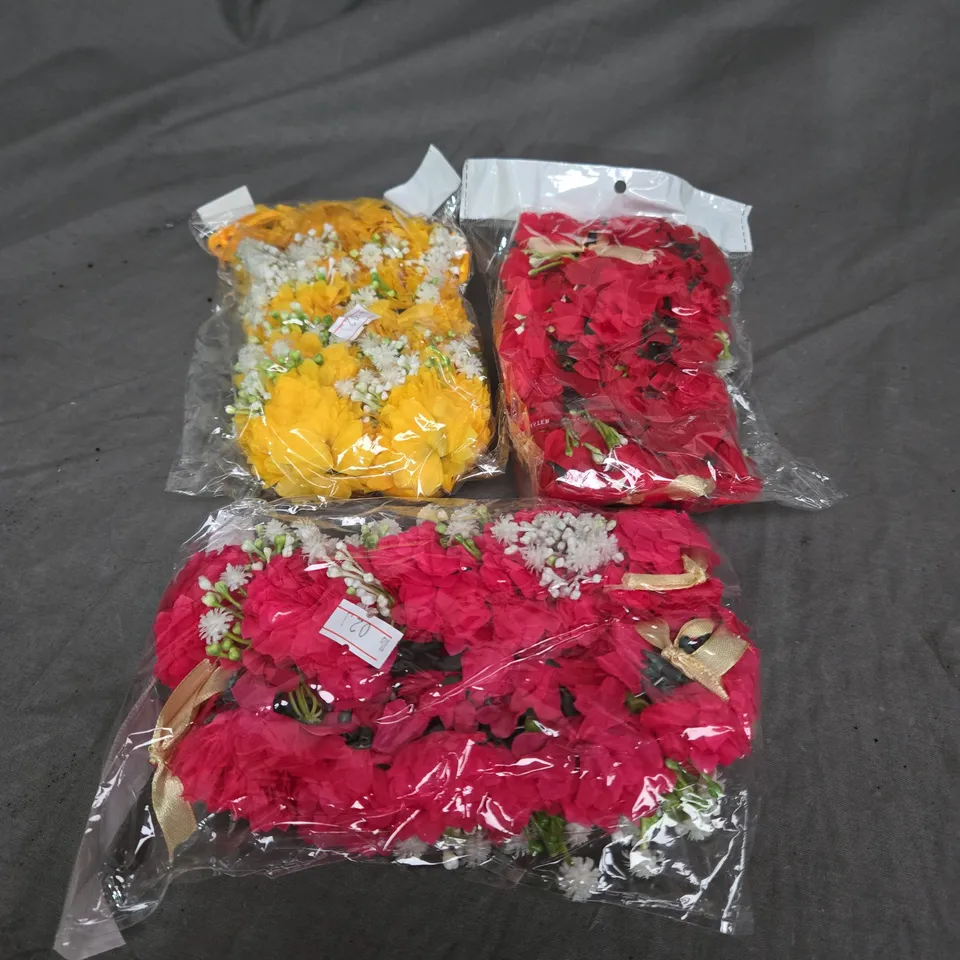 LARGE QUANTITY OF ARTIFICIAL FLOWER DECORATIONS IN ASSORTED COLOURS TO INCLUDE - YELLOW - PINK - RED