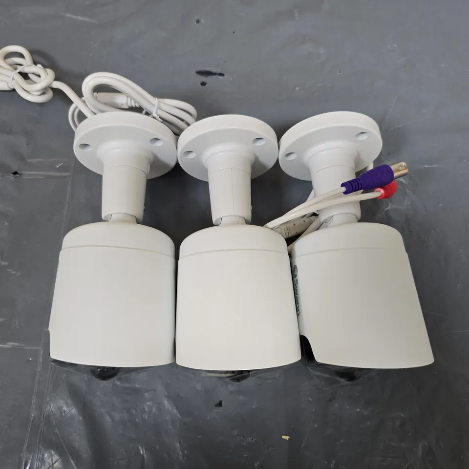 SWANN THREE WHITE BULLET CCTV SURVEILLANCE CAMERAS WITH MOUNTING BASES AND CABLES