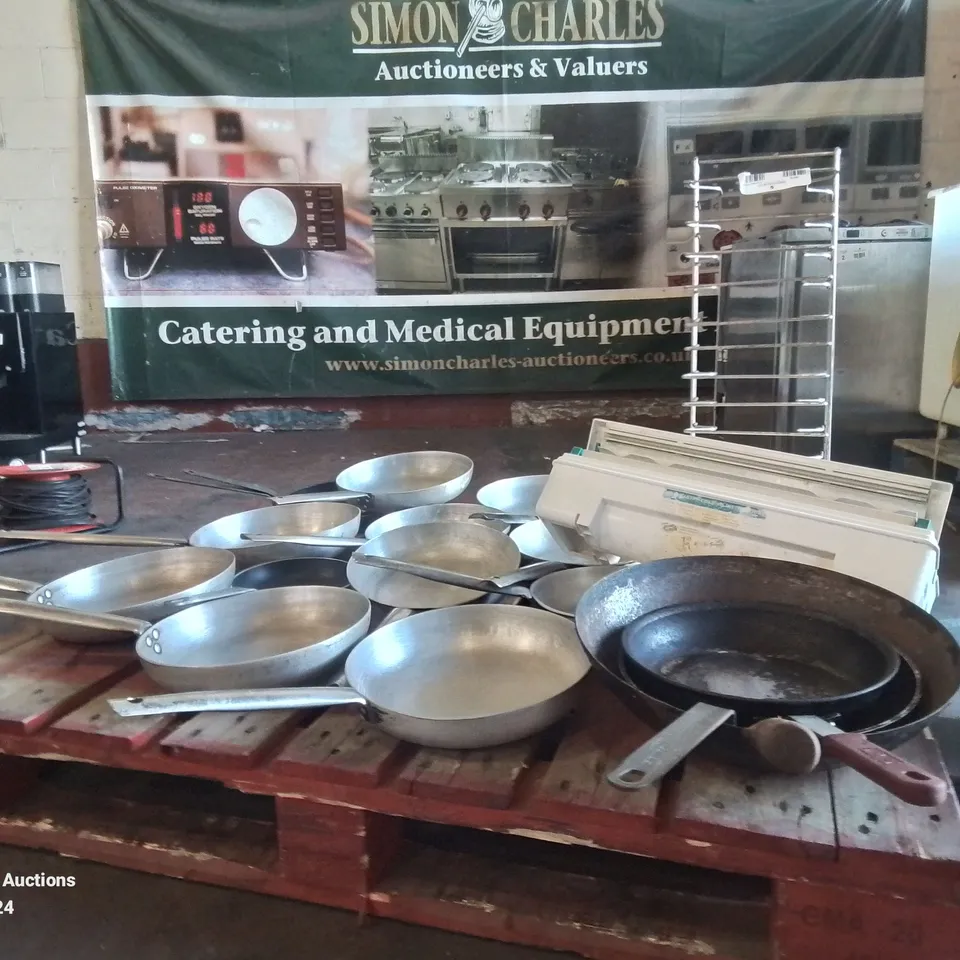 LARGE AMOUNT OF COMMERCIAL FRYING PANS AND STAINLESS STEEL PLATE RACK AND FOOD PACKAGING CUTTER
