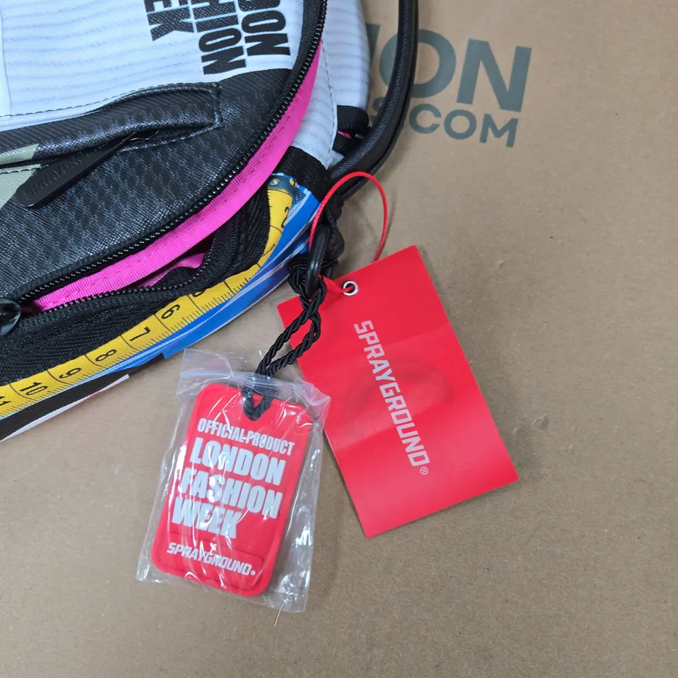 SPRAYGROUND LONDON FASHION WEEK BACKPACK – MULTICOLOURED GRAPHIC DESIGN WITH TAGS