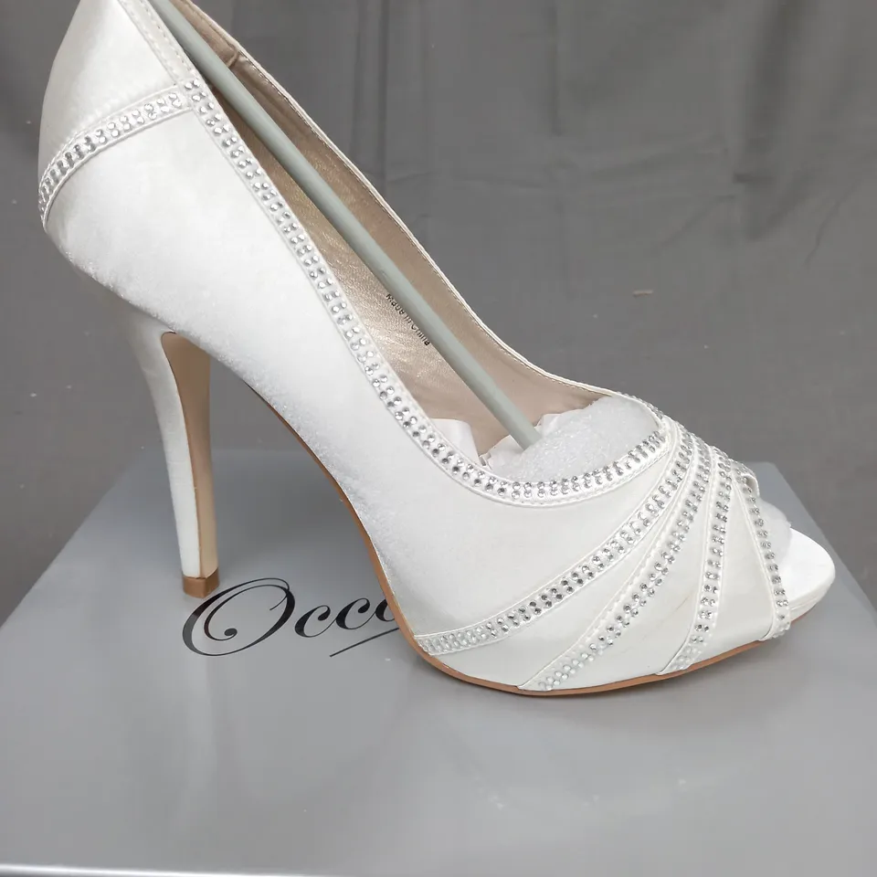 BOX OF 14 PAIRS OF IVORY SATIN HIGH HEELED SHOES 