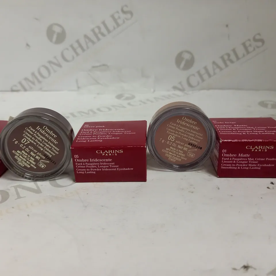 LOT OF APPROXIMATELY 32 CLARINS OMBRE CREAM EYESHADOWS IN SILVER PINK, SILVER PLUM & NUDE BEIGE