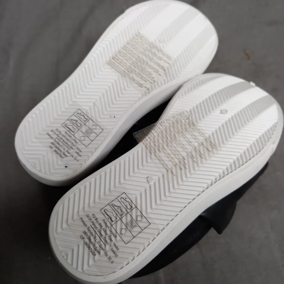 BOX OF APPROXIMATELY 10 PAIRS OF JUNIOR LOW BLACK AND WHITE BOW SHOES 