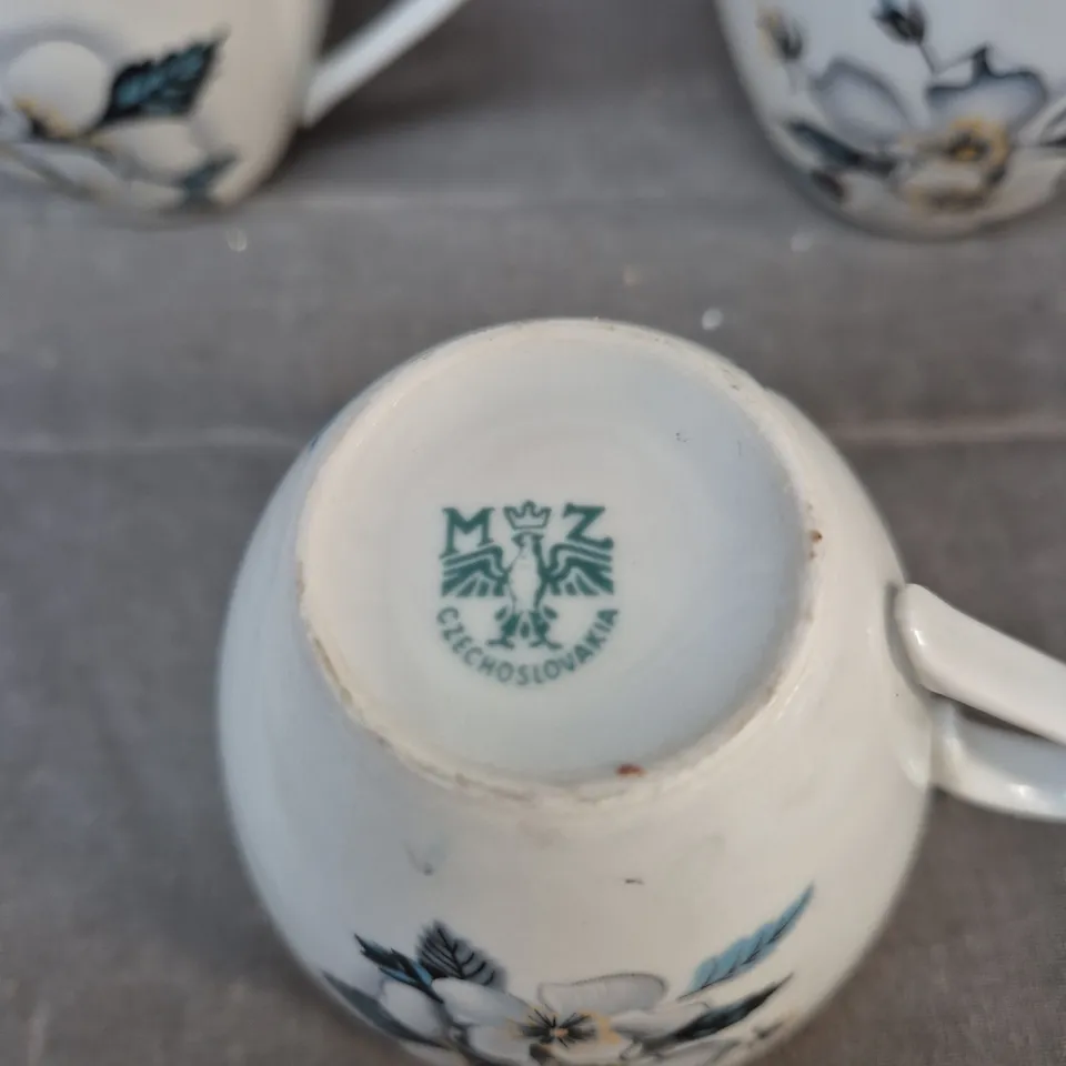 THREE PORCELAIN TEACUPS WITH BLUE FLORAL DESIGN AND GILT RIMS – CZECH/CZECHOSLOVAKIA MARK