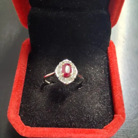 18CT WHITE GOLD CLUSTER RING SET WITH AN OVAL CUT RUBY AND NATURAL BAGUETTE CUT DIAMOND
