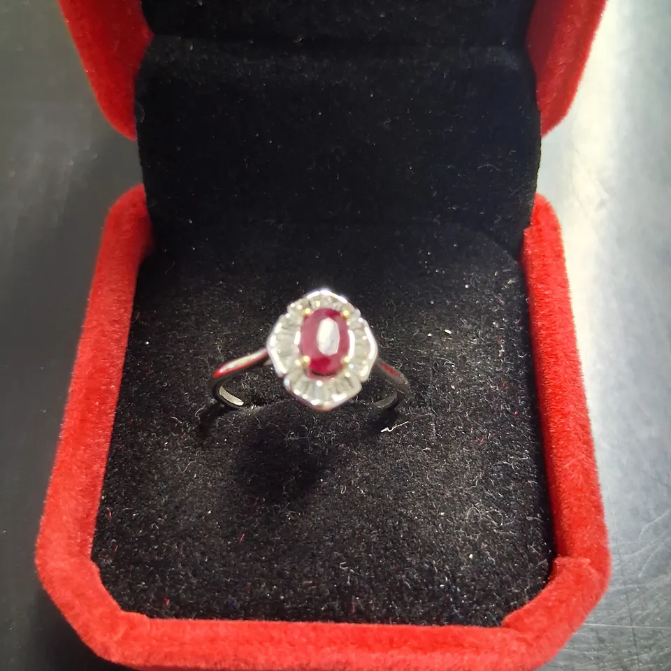 18CT WHITE GOLD CLUSTER RING SET WITH AN OVAL CUT RUBY AND NATURAL BAGUETTE CUT DIAMOND