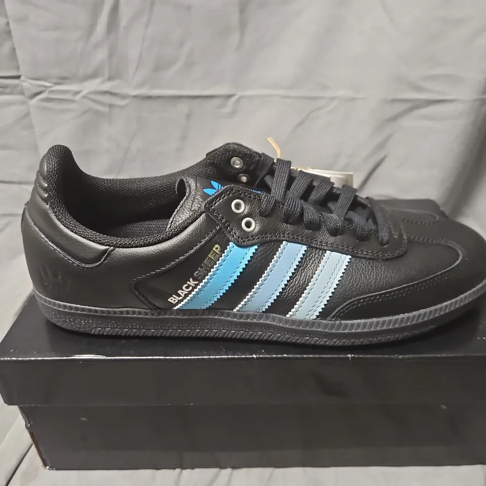 BOXED ADIDAS BLACK SHEEP SNEAKERS – UK 9 (US 9.5), BLACK WITH LIGHT BLUE STRIPES